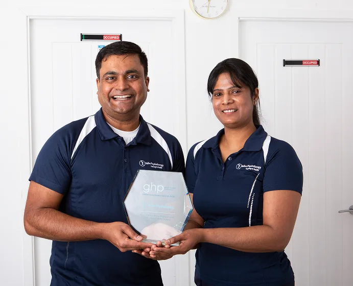 Raj and Mohana Nedunchezian holding GHP Healthcare Award - Relive Physiotherapy